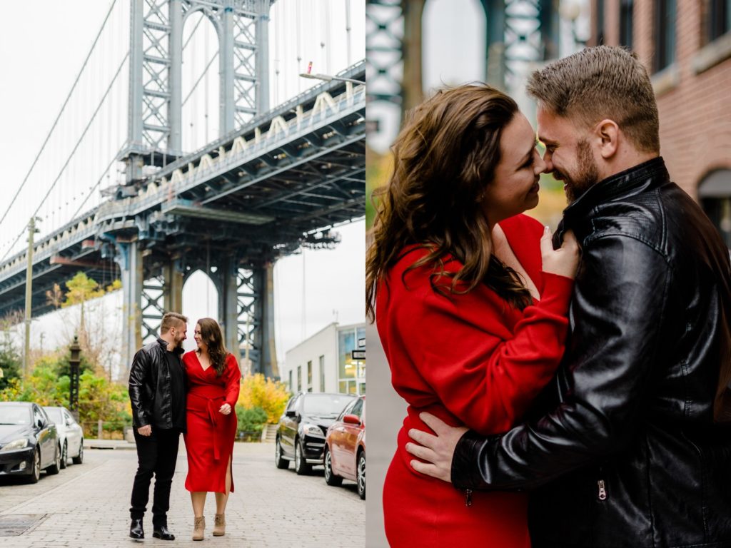 a couple standing in front of the manhattan bridge holding hands and looking at each other. 