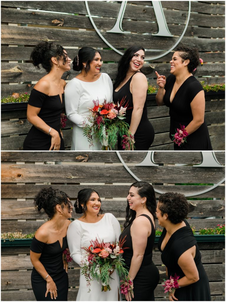 a group of bridesmaids in black dressed laughing with the bride in a white dress. 