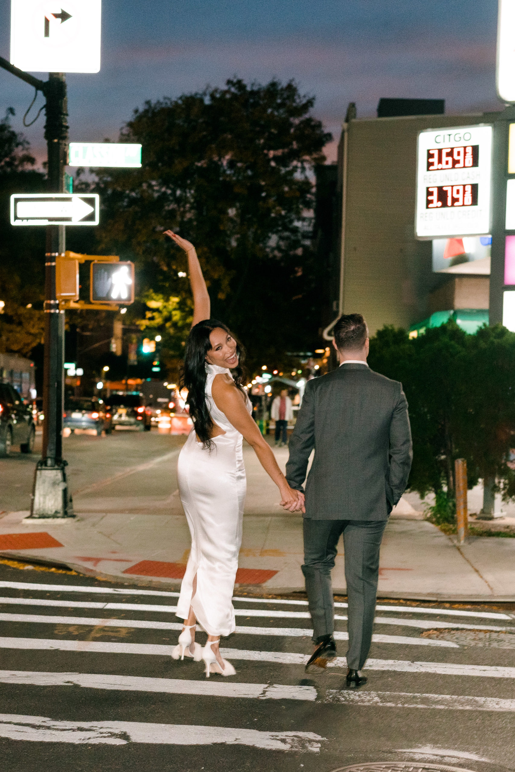 a couple walking across a cross walk in NYC