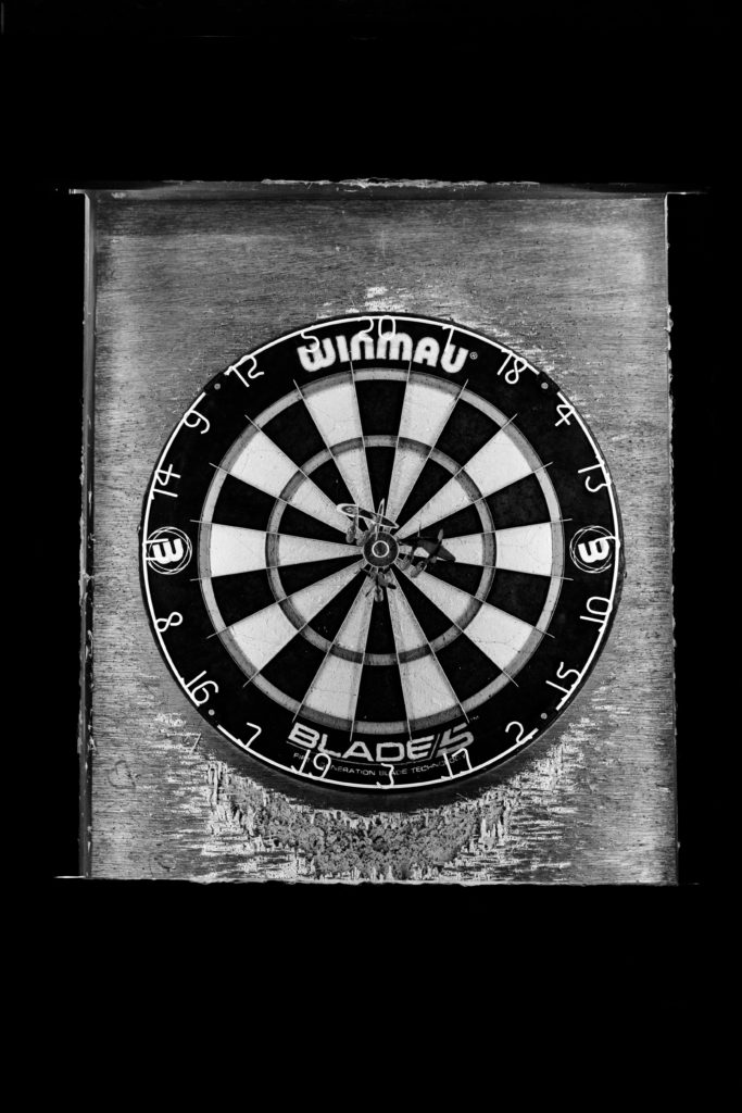 a dart board at a bar