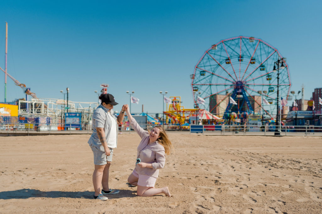 lesbian couple proposing in front of the Coney Island Wonder Wheel
