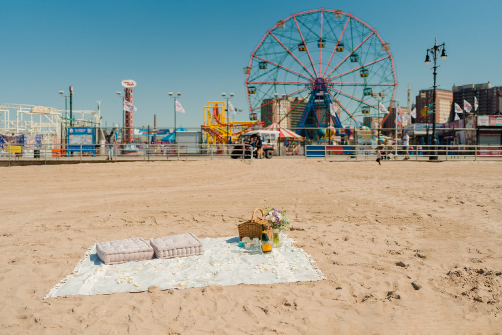 a picnic set up in front of the coney island wonder wheel