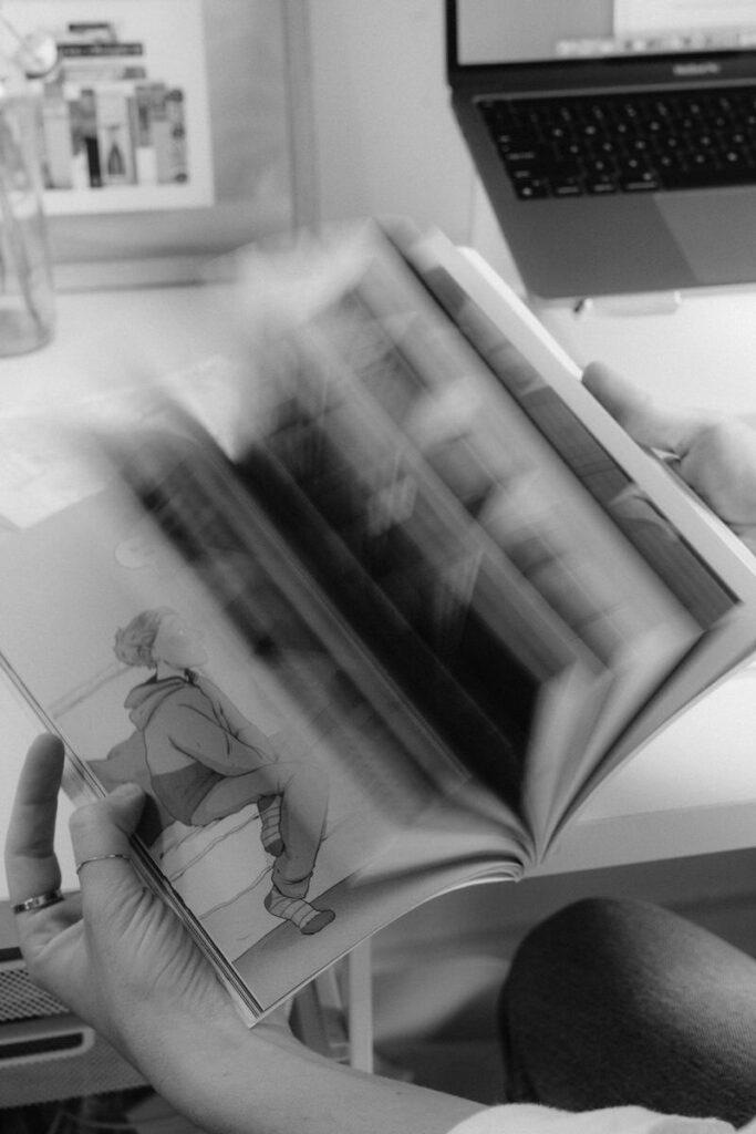 Black and white image of the pages of a book flipping. 