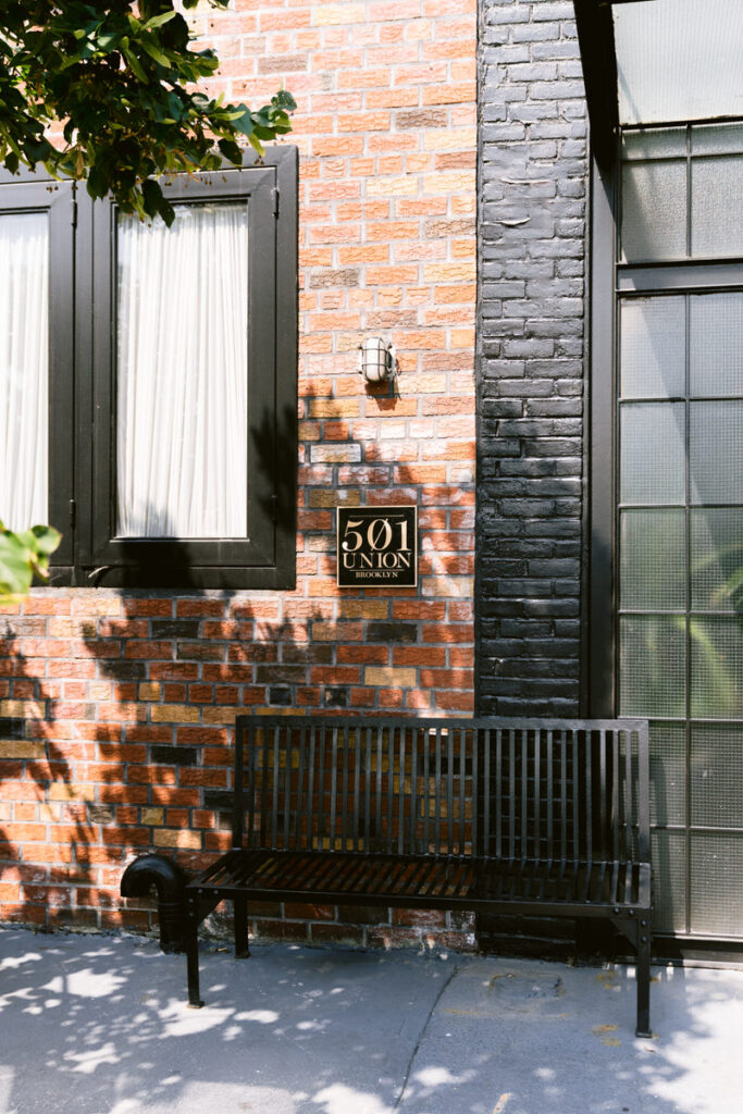 The outside of a brick building with a bench in front of it and a sign that reads "501 Union"
