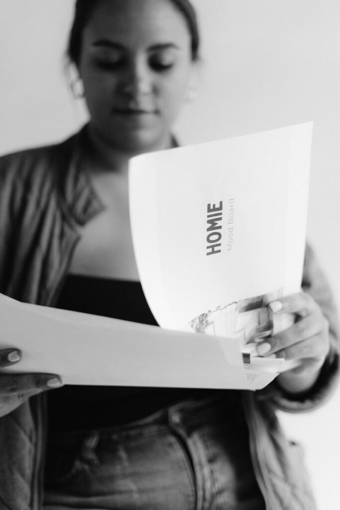 Black and white photo of a person flipping through papers 
