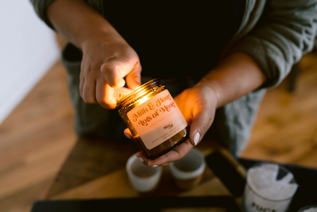 A person lighting a small candle 
