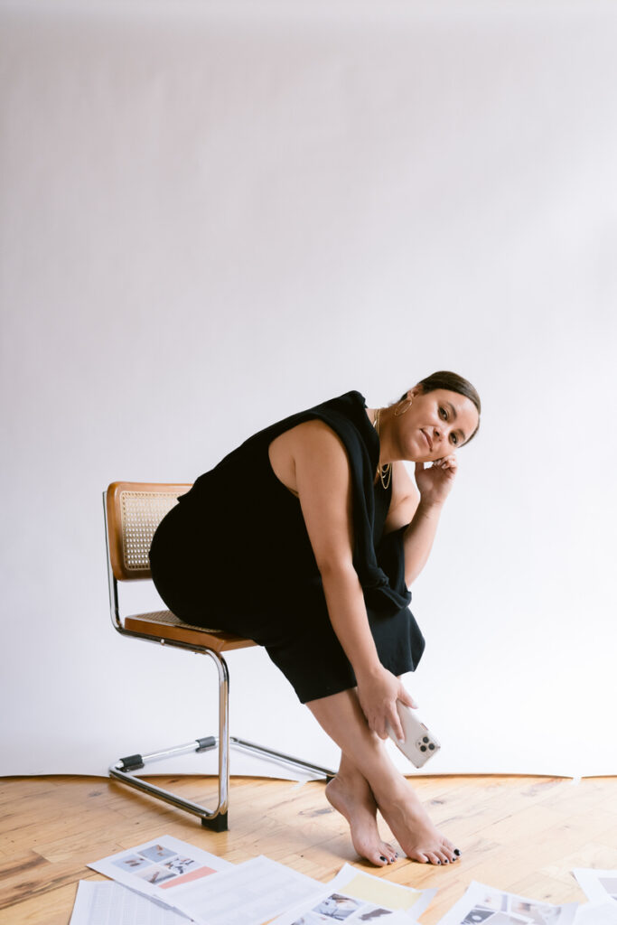 A person leaning over in a chair smiling 
